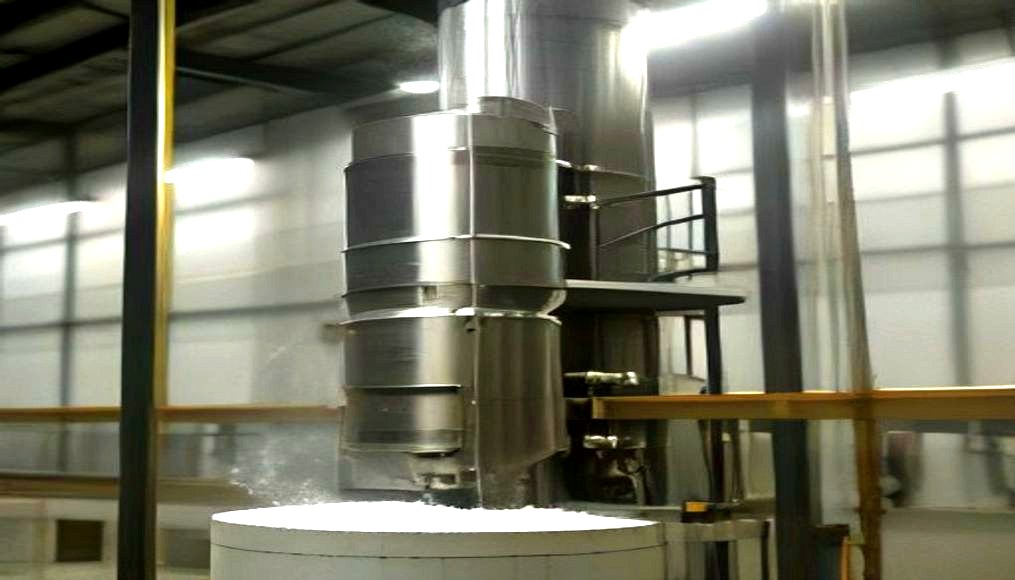 Auger powder filling machine dosing powder into jars on a conveyor